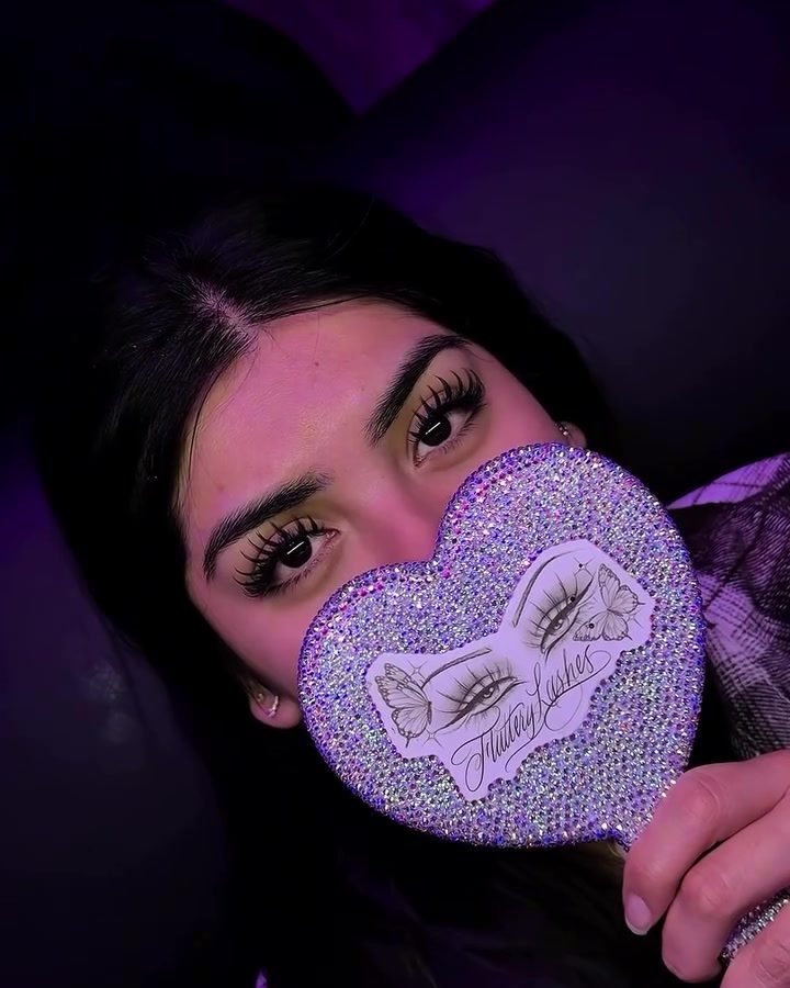 Client showing her fresh set behind the rhinestone heart mirror
